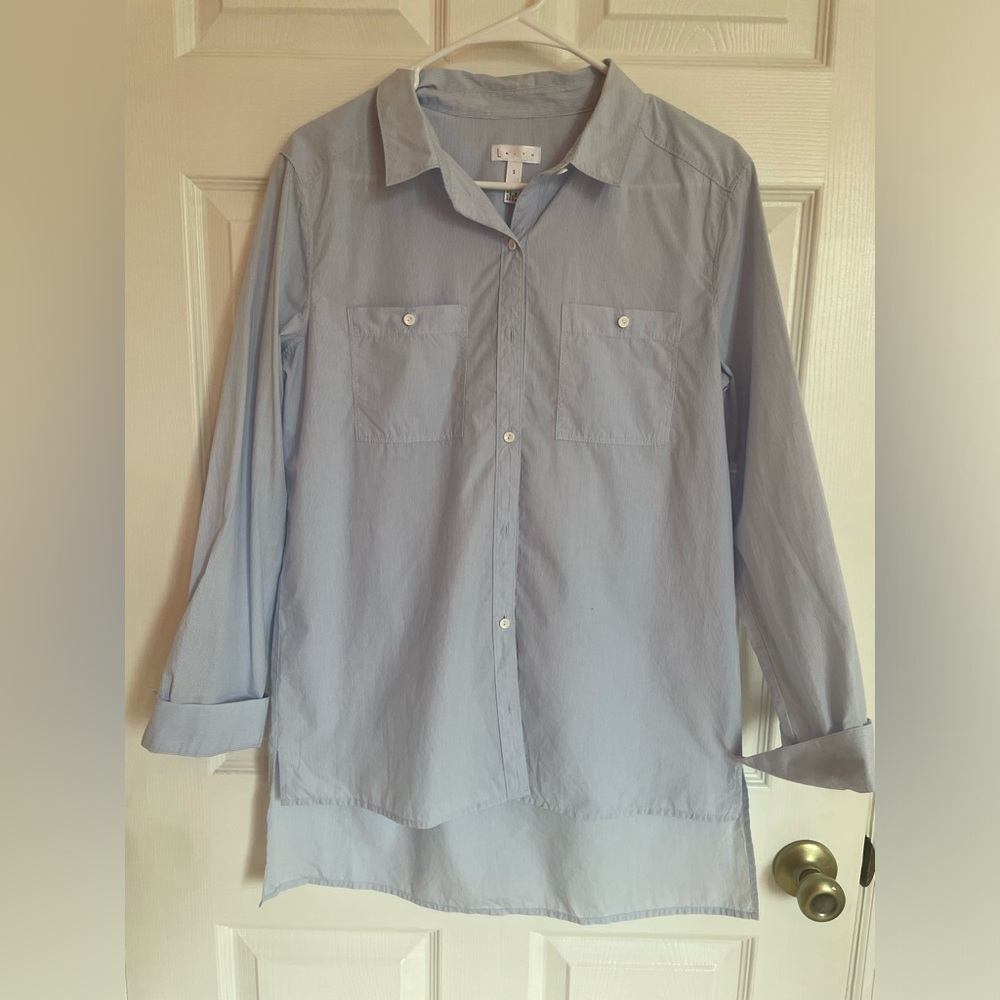Blue and white striped button down shirt. Never Worn. Extra button attached.